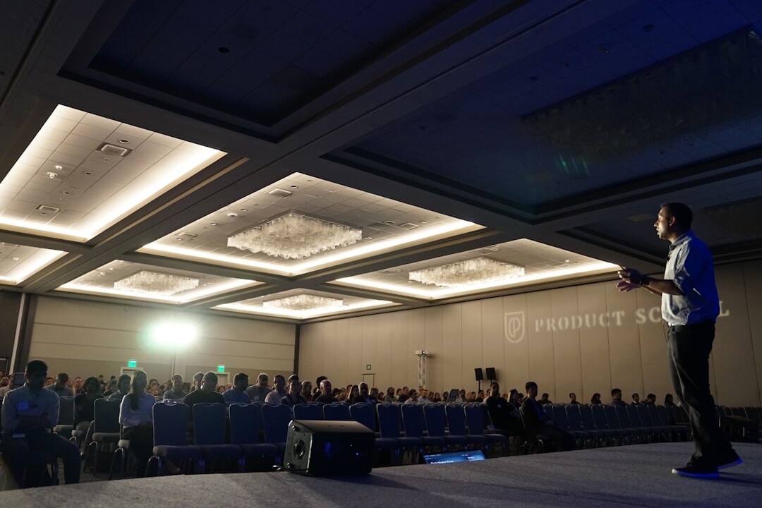Conference moderator on stage speaking to audience